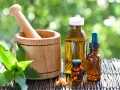 Mortier en bois, flacons d'huiles essentielles et comprimés, un remède pour la digestion à base de plantes.