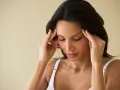 Femme se massant les tempes, cherchant à soulager une migraine en 30 secondes.